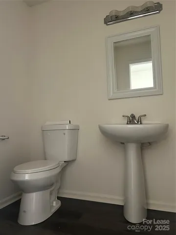 a bathroom with a sink toilet and a mirror