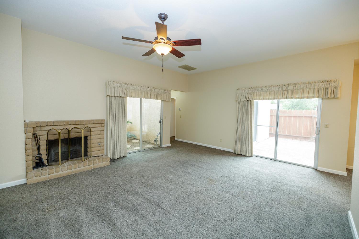 1124 Tasmania Way Modesto, CA 95356 - Photo 11 of 34 an empty room with windows and fireplace