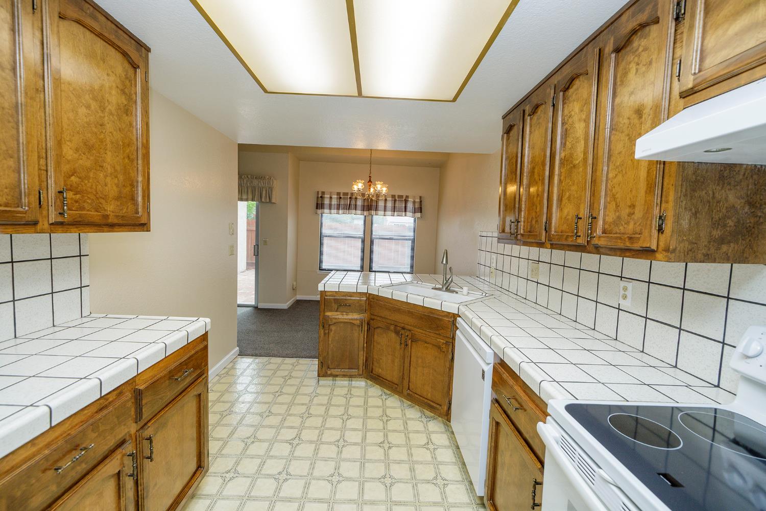 1124 Tasmania Way Modesto, CA 95356 - Photo 20 of 34 a kitchen with a sink stove and cabinets
