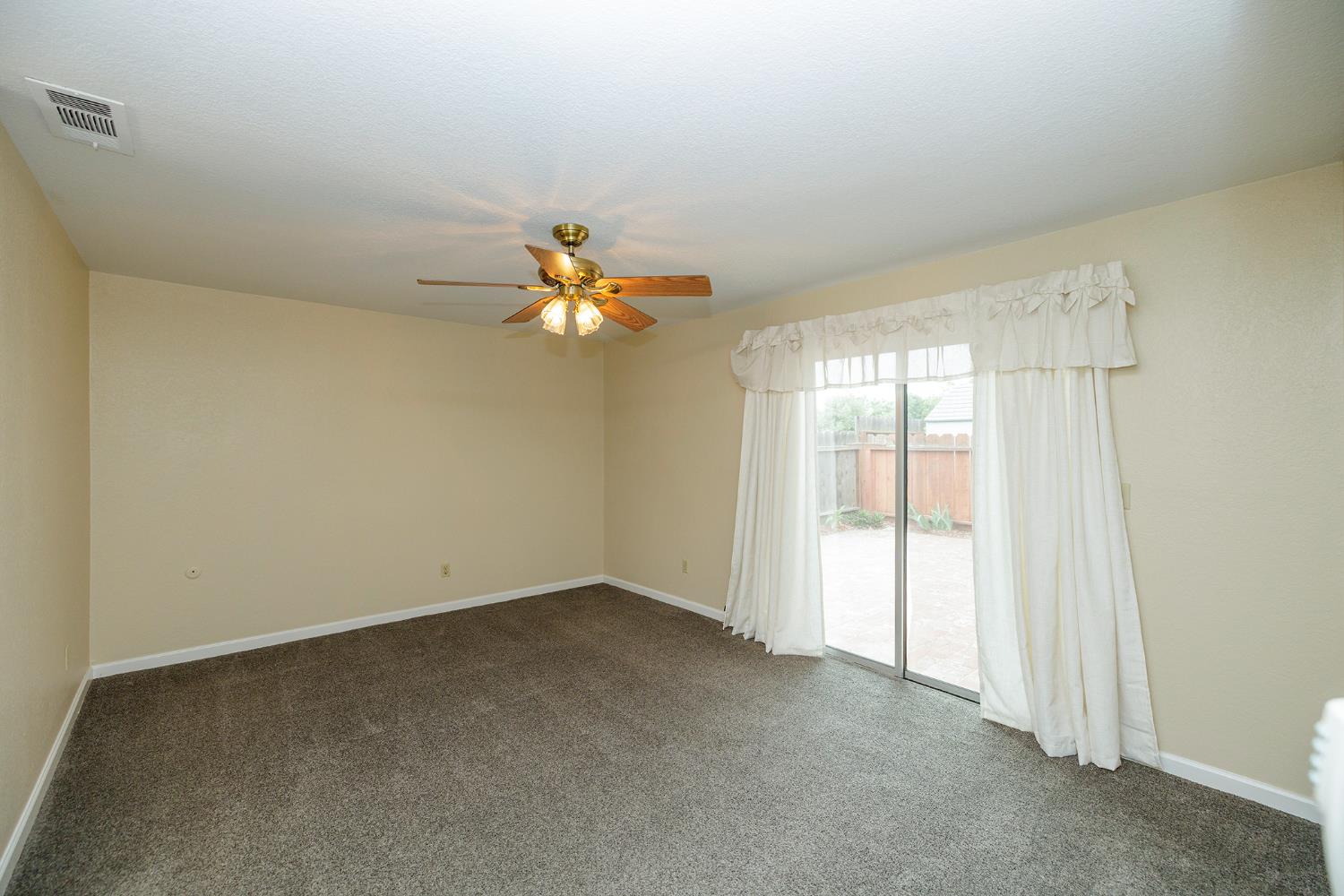 1124 Tasmania Way Modesto, CA 95356 - Photo 21 of 34 wooden floor in an empty room with a window