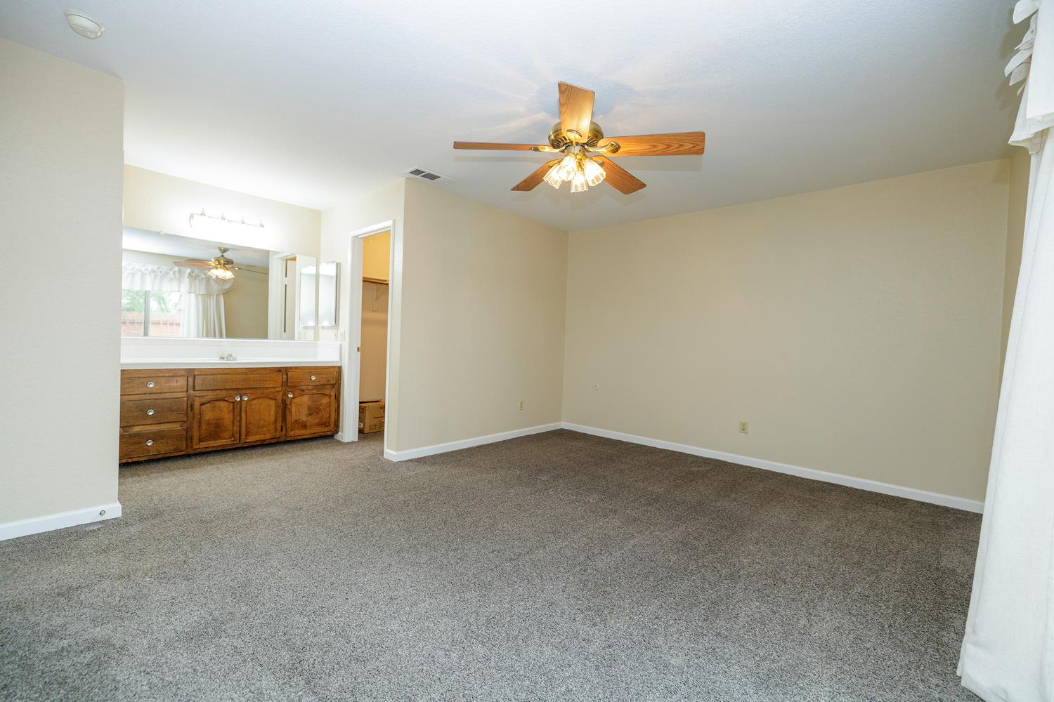 1124 Tasmania Way Modesto, CA 95356 - Photo 23 of 34 a view of a room with a ceiling fan and window