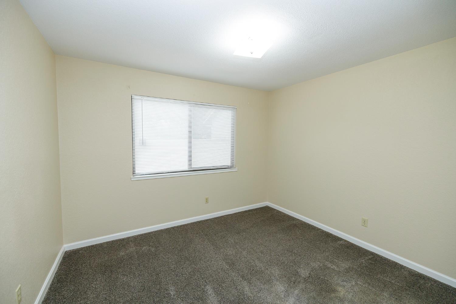 1124 Tasmania Way Modesto, CA 95356 - Photo 27 of 34 an empty room with a window