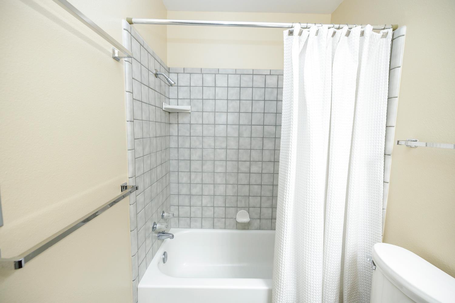 1124 Tasmania Way Modesto, CA 95356 - Photo 30 of 34 a bathroom with a shower and a bathtub