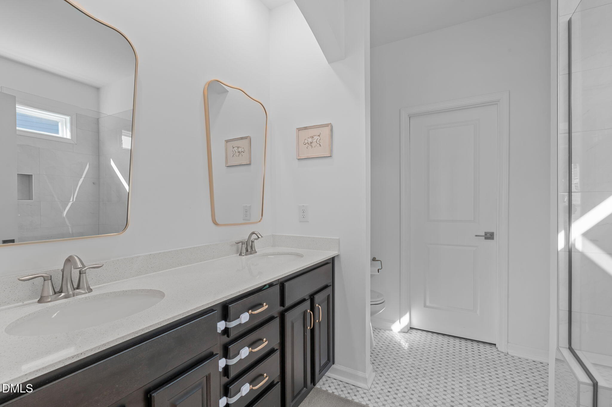6616 Truxton Lane Raleigh, NC 27616 - Photo 10 of 42 a bathroom with a double vanity sink and a mirror