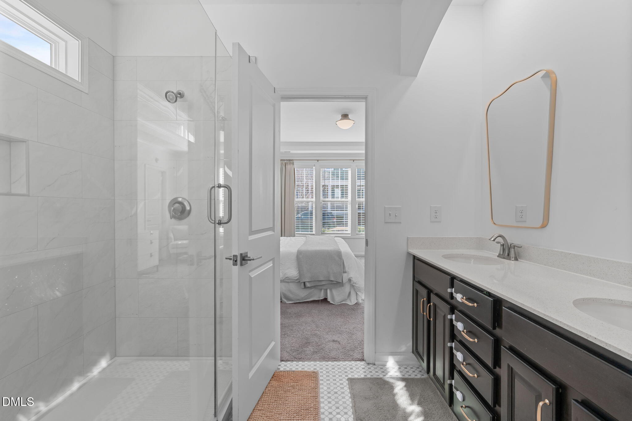 6616 Truxton Lane Raleigh, NC 27616 - Photo 11 of 42 a bathroom with a double vanity sink a mirror and a shower
