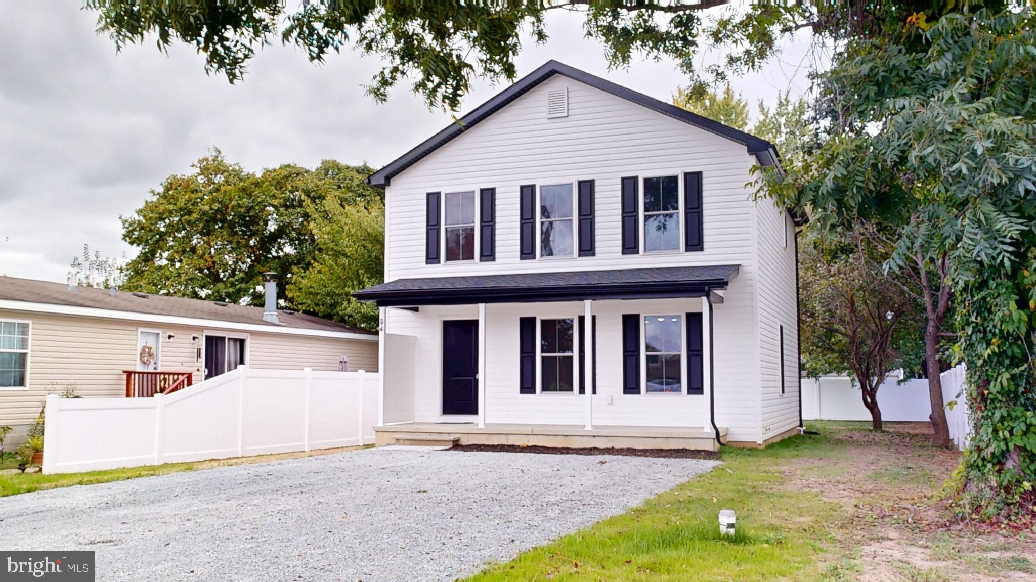99 Cooper Street Kenton, DE 19938 - Photo 1 of 43 a view of white house with a small yard and large trees