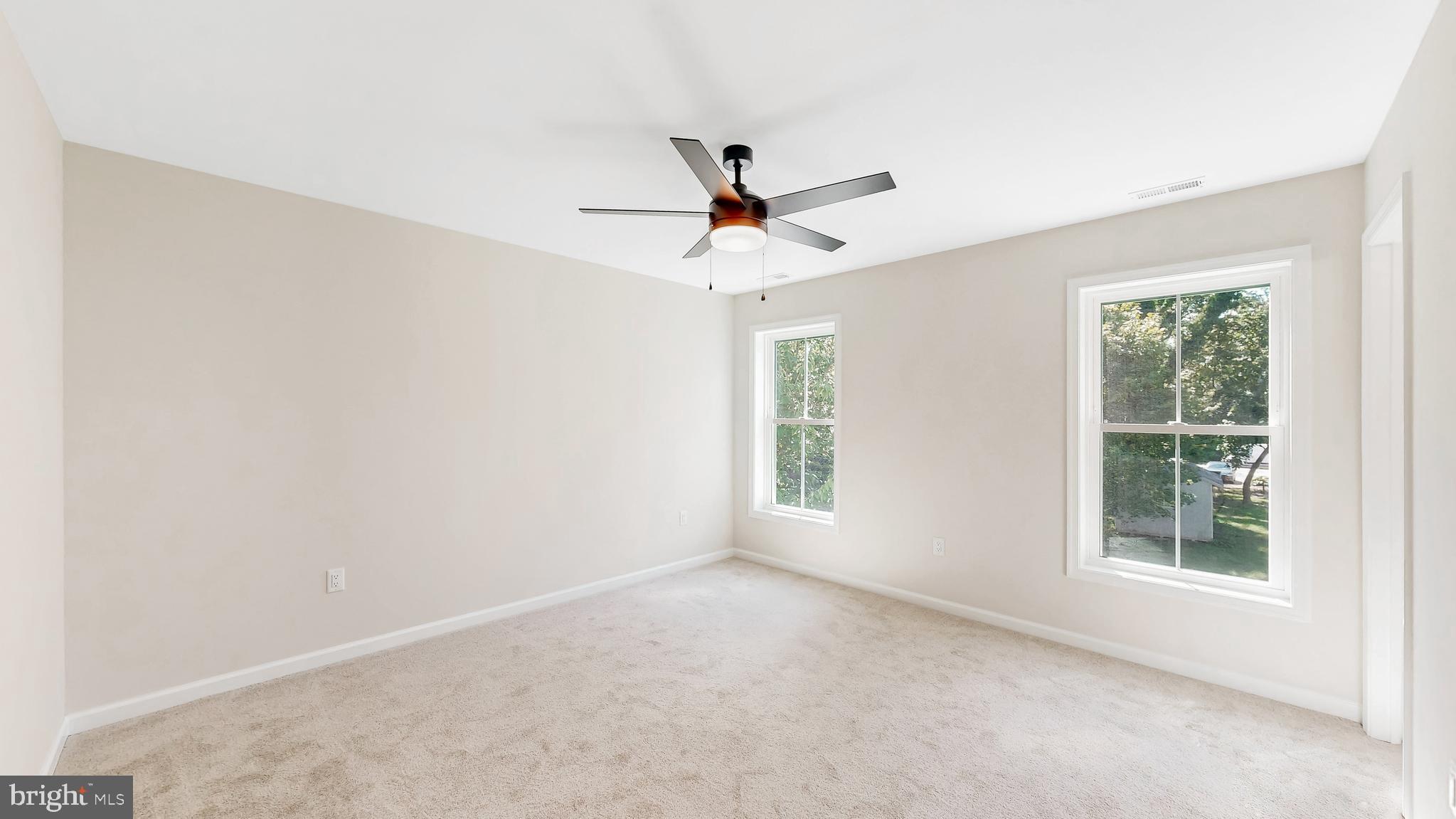 99 Cooper Street Kenton, DE 19938 - Photo 16 of 43 an empty room with a window and a ceiling fan