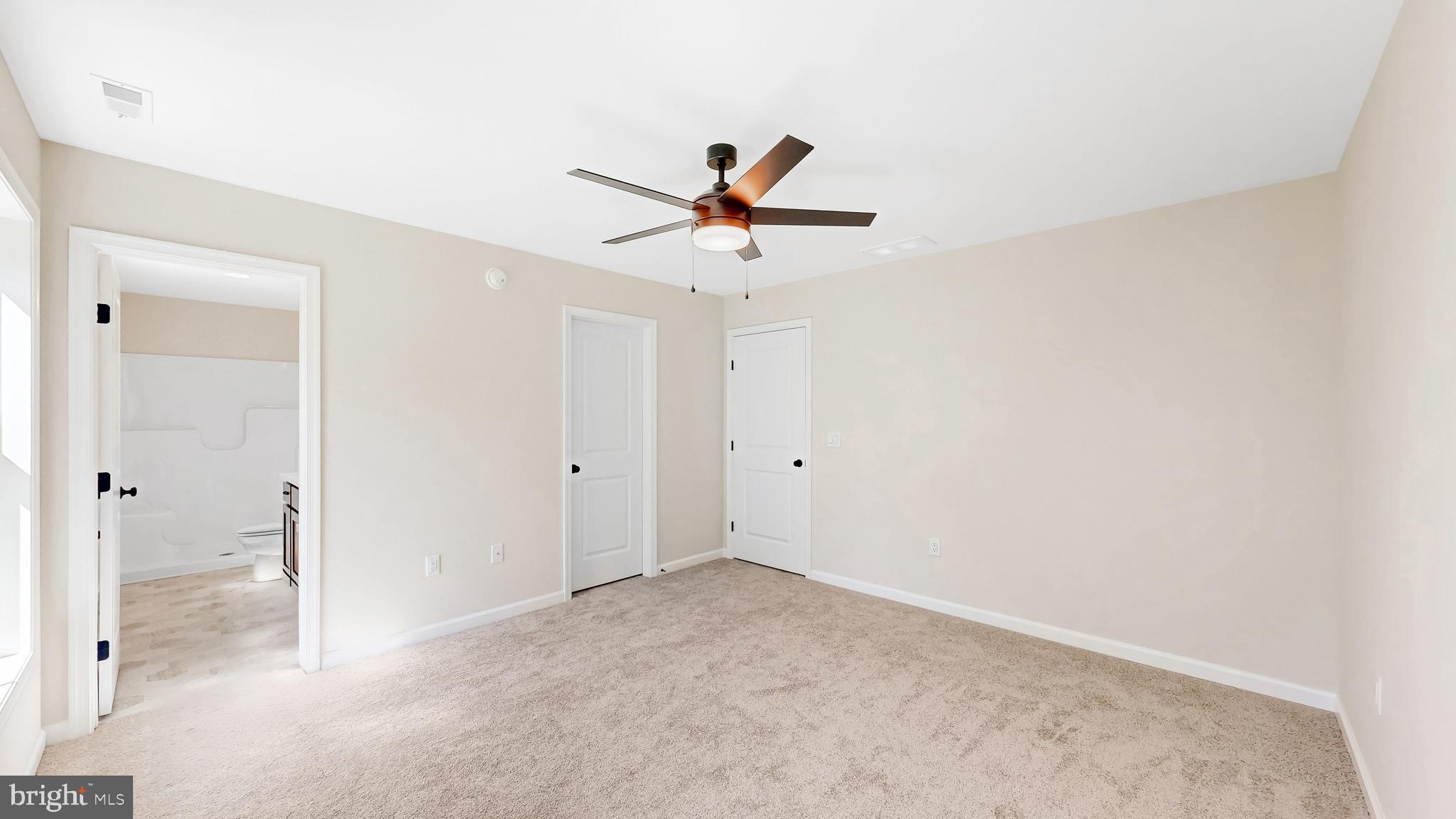 99 Cooper Street Kenton, DE 19938 - Photo 18 of 43 a view of a room with a ceiling fan and carpet