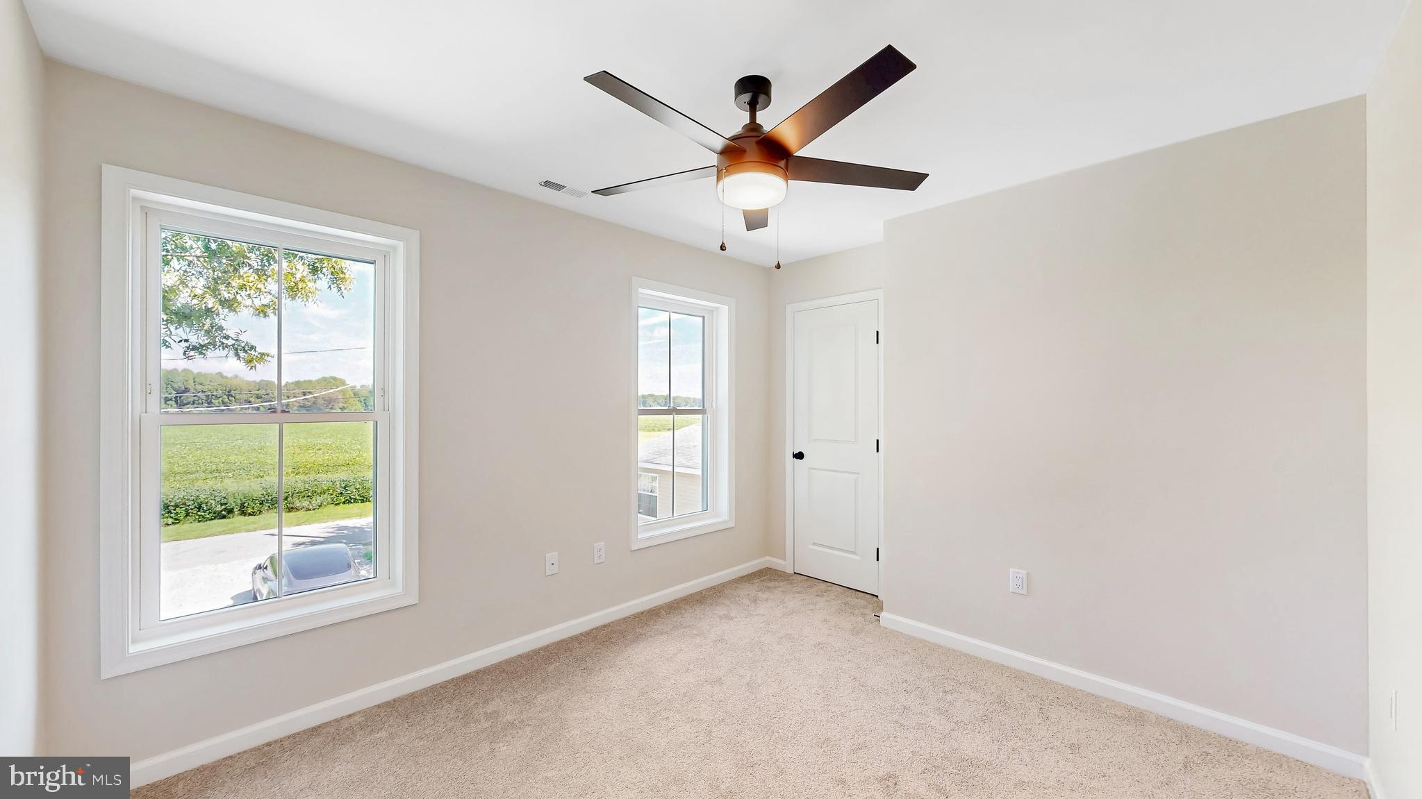 99 Cooper Street Kenton, DE 19938 - Photo 21 of 43 an empty room with windows and fan