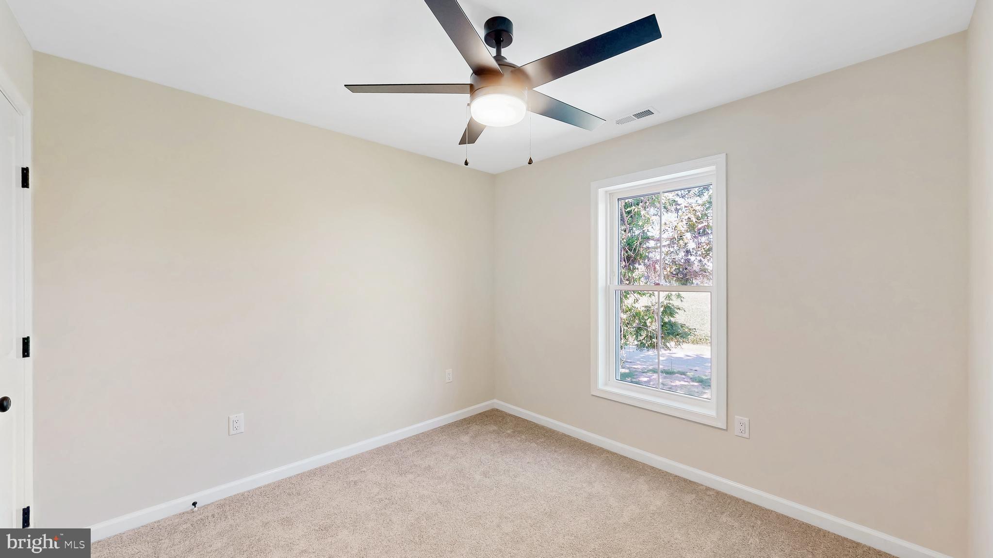 99 Cooper Street Kenton, DE 19938 - Photo 23 of 43 an empty room with a window and a fan