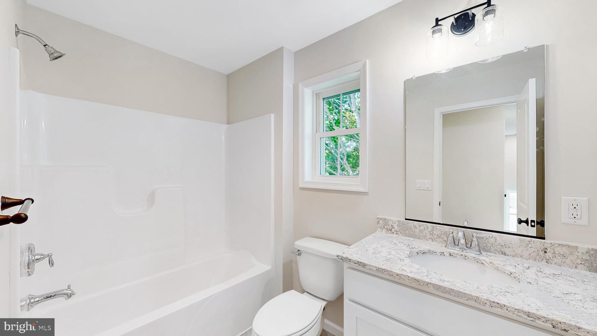 99 Cooper Street Kenton, DE 19938 - Photo 25 of 43 a bathroom with a granite countertop sink toilet and shower