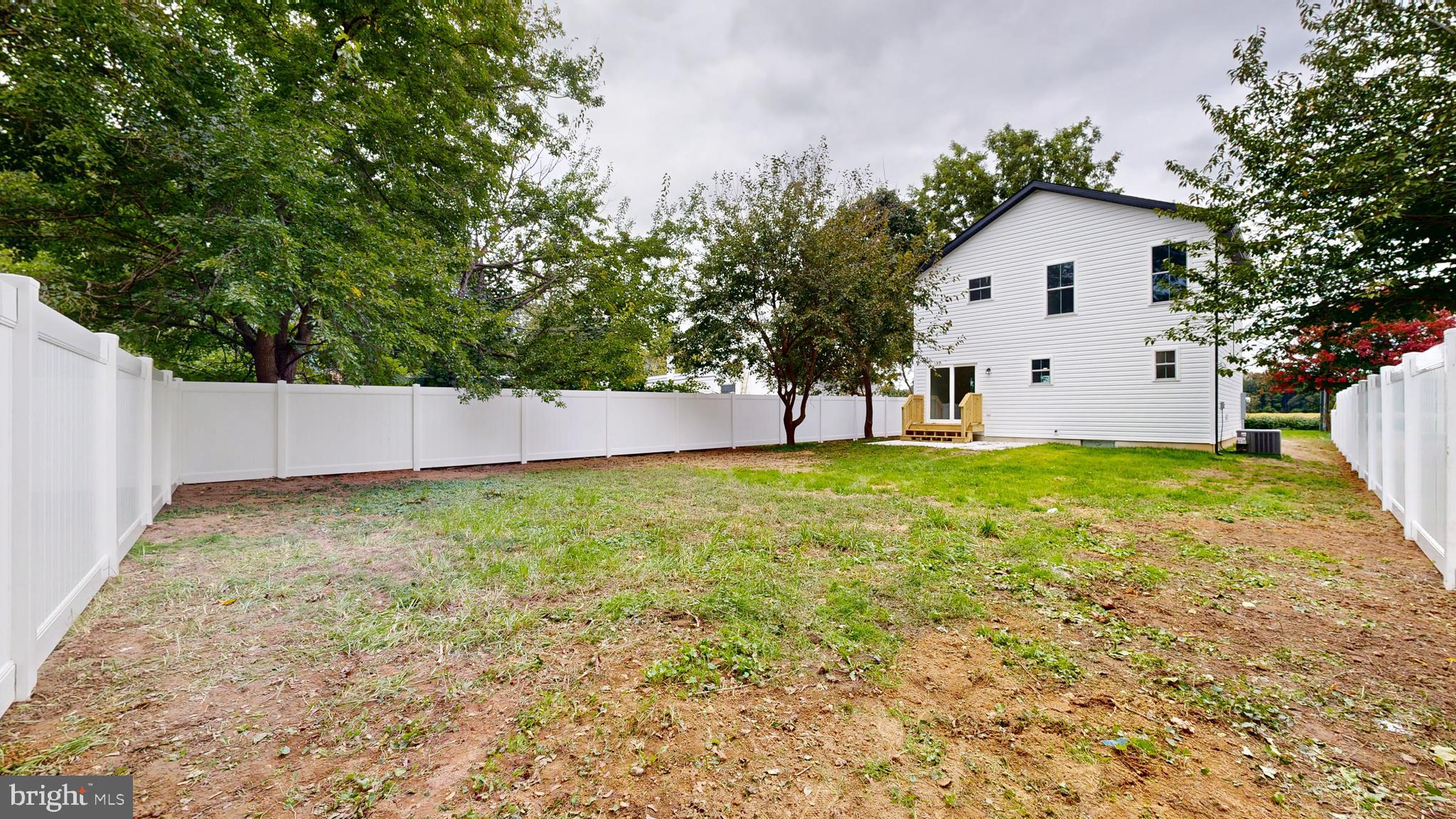 99 Cooper Street Kenton, DE 19938 - Photo 31 of 43 a view of backyard with large trees and wooden fence