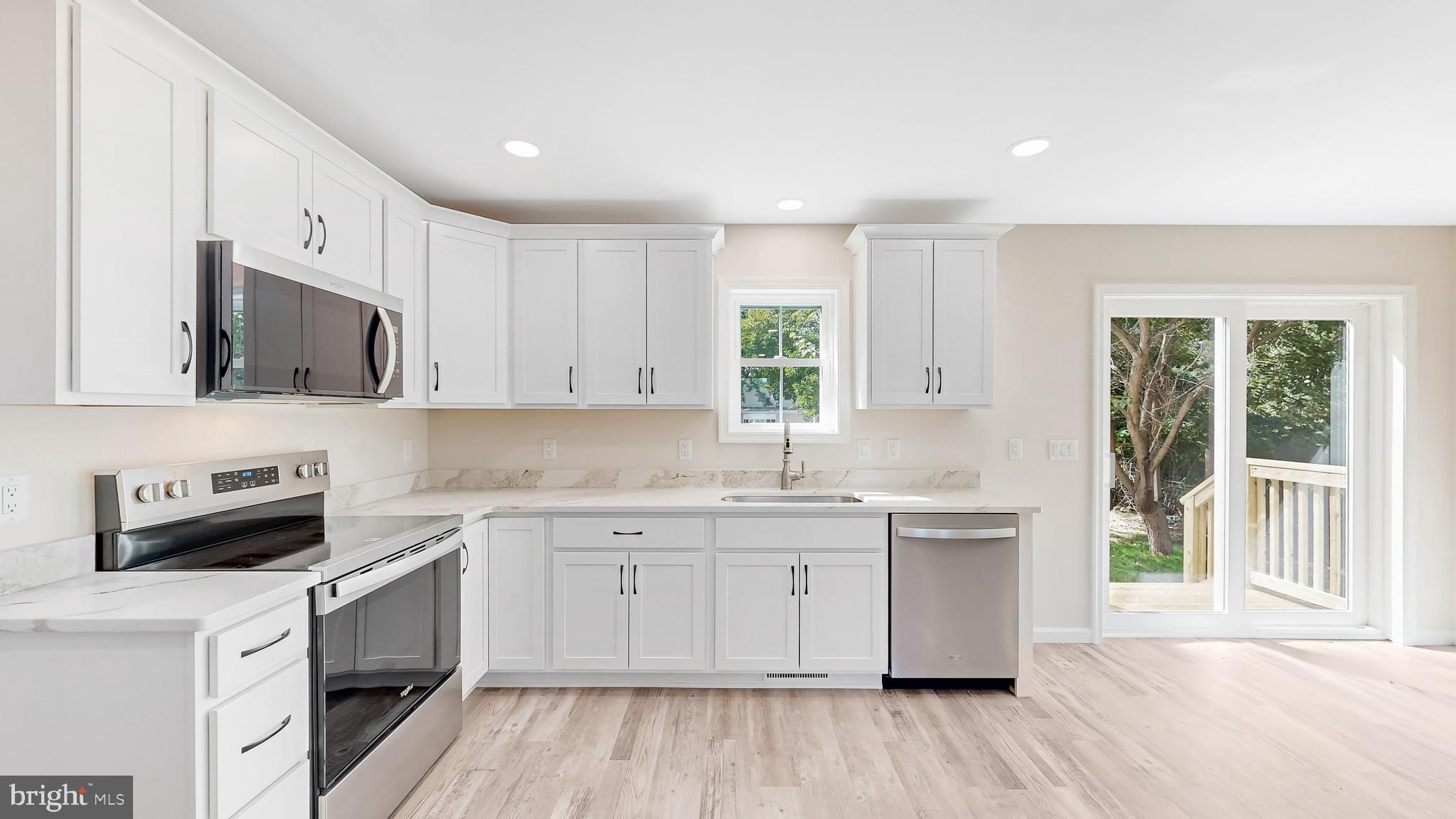 99 Cooper Street Kenton, DE 19938 - Photo 6 of 43 a kitchen with a sink stove and microwave