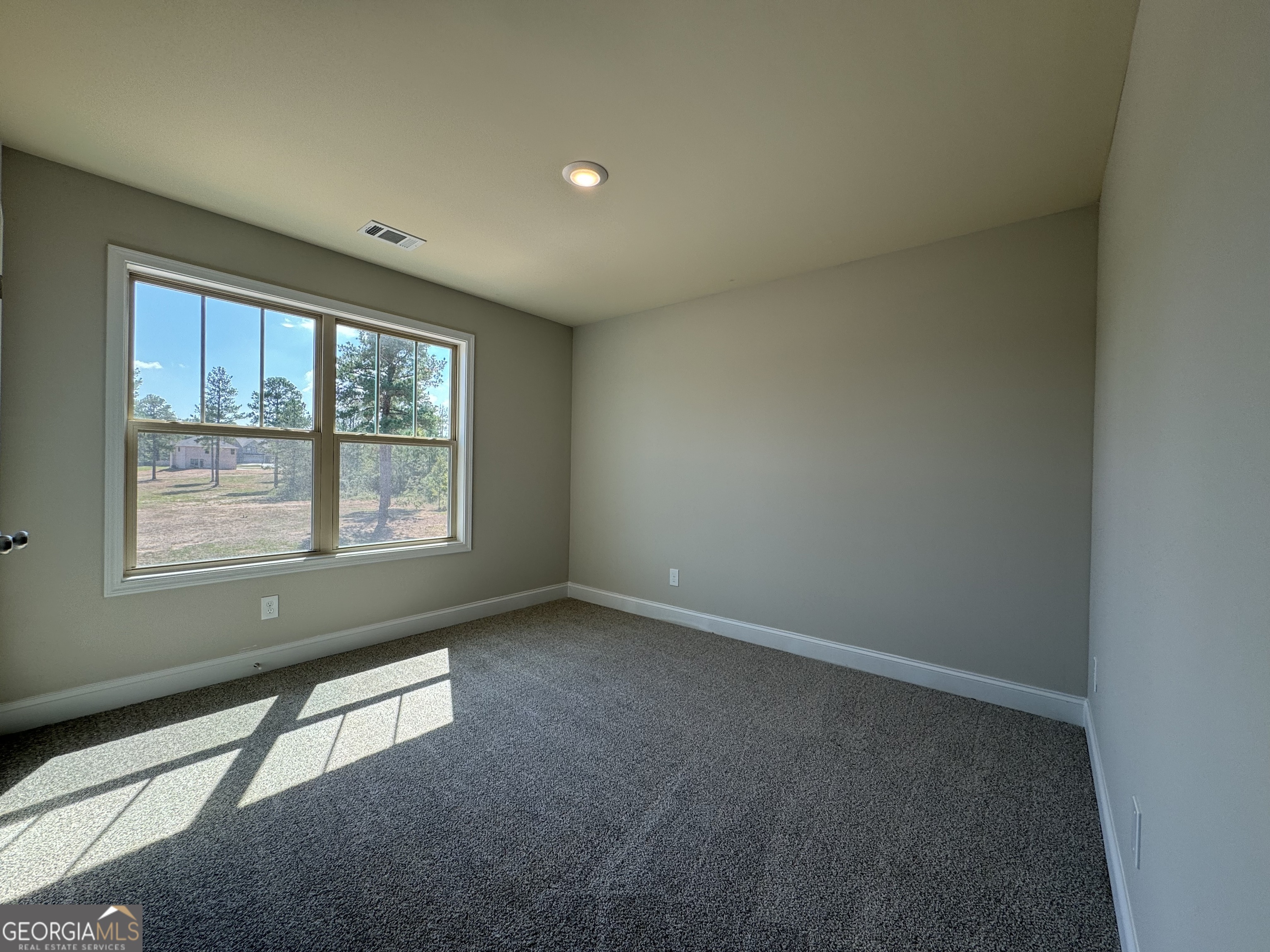 166 Country World Drive Macon, GA 31211 - Photo 11 of 33 an empty room with a window