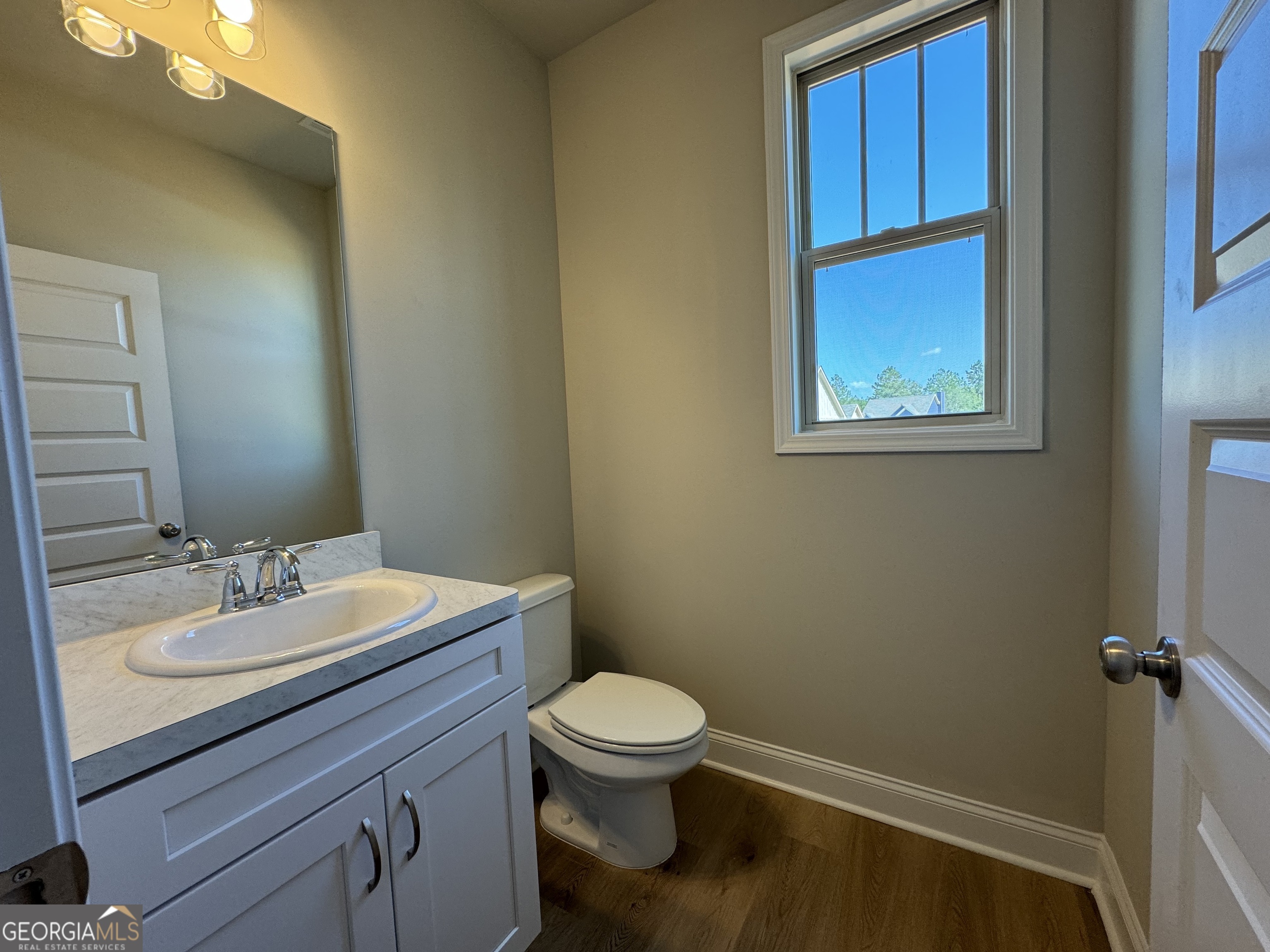 166 Country World Drive Macon, GA 31211 - Photo 14 of 33 a bathroom with a toilet a sink and mirror