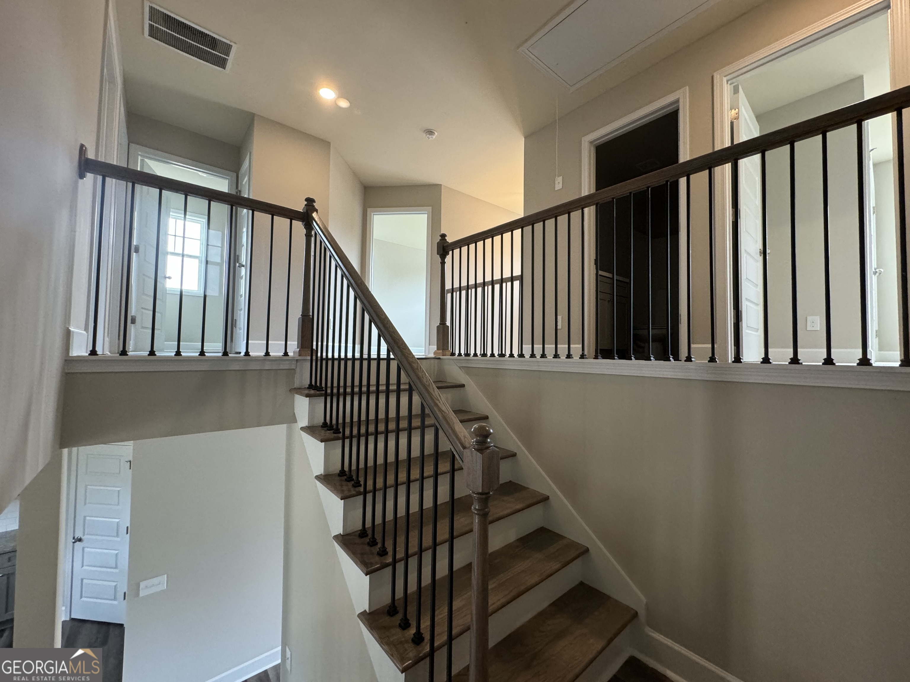 166 Country World Drive Macon, GA 31211 - Photo 18 of 33 a view of staircase with lots of frames on wall and a window