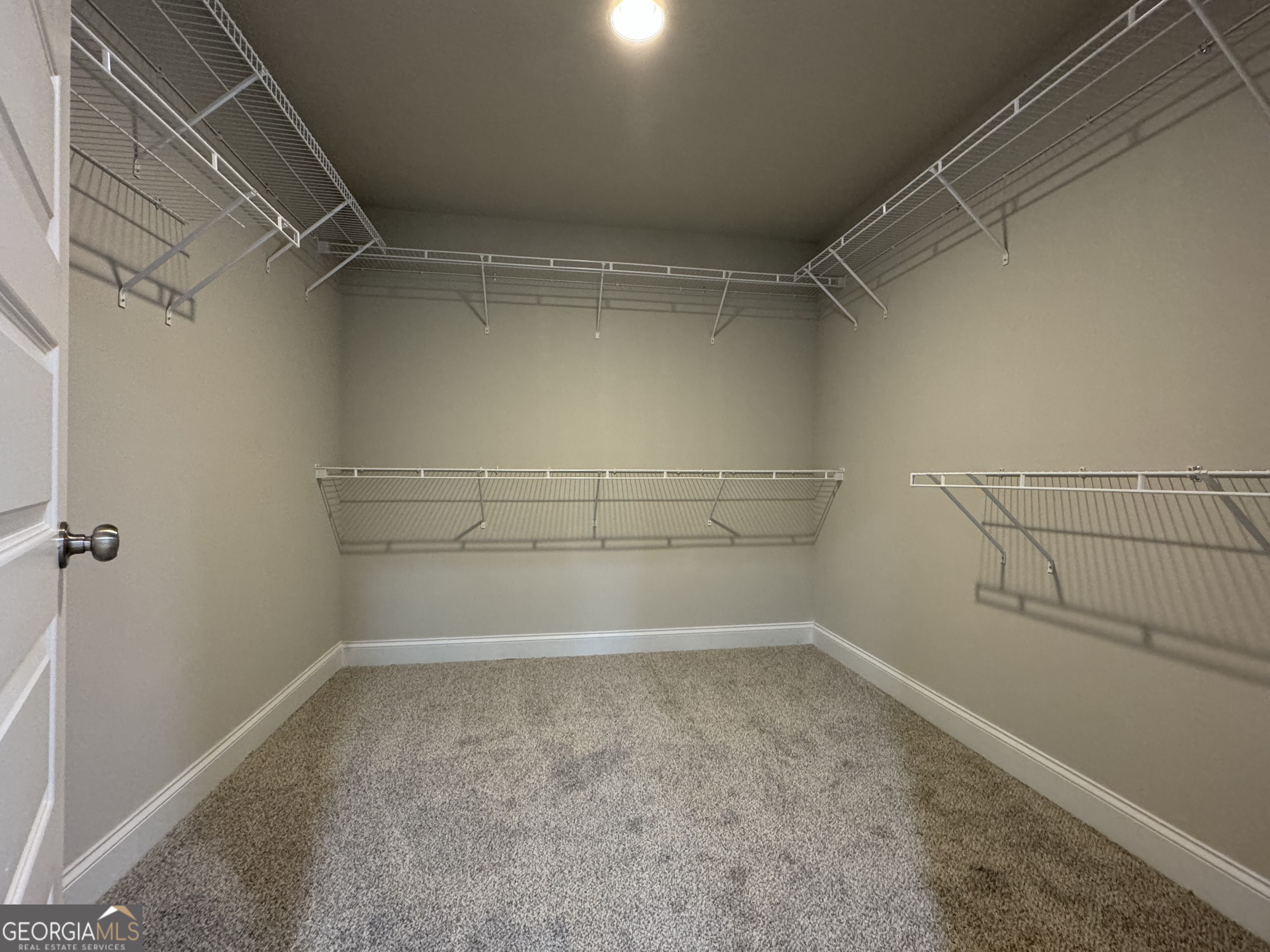 166 Country World Drive Macon, GA 31211 - Photo 20 of 33 a view of storage and utility room with racks on the wall