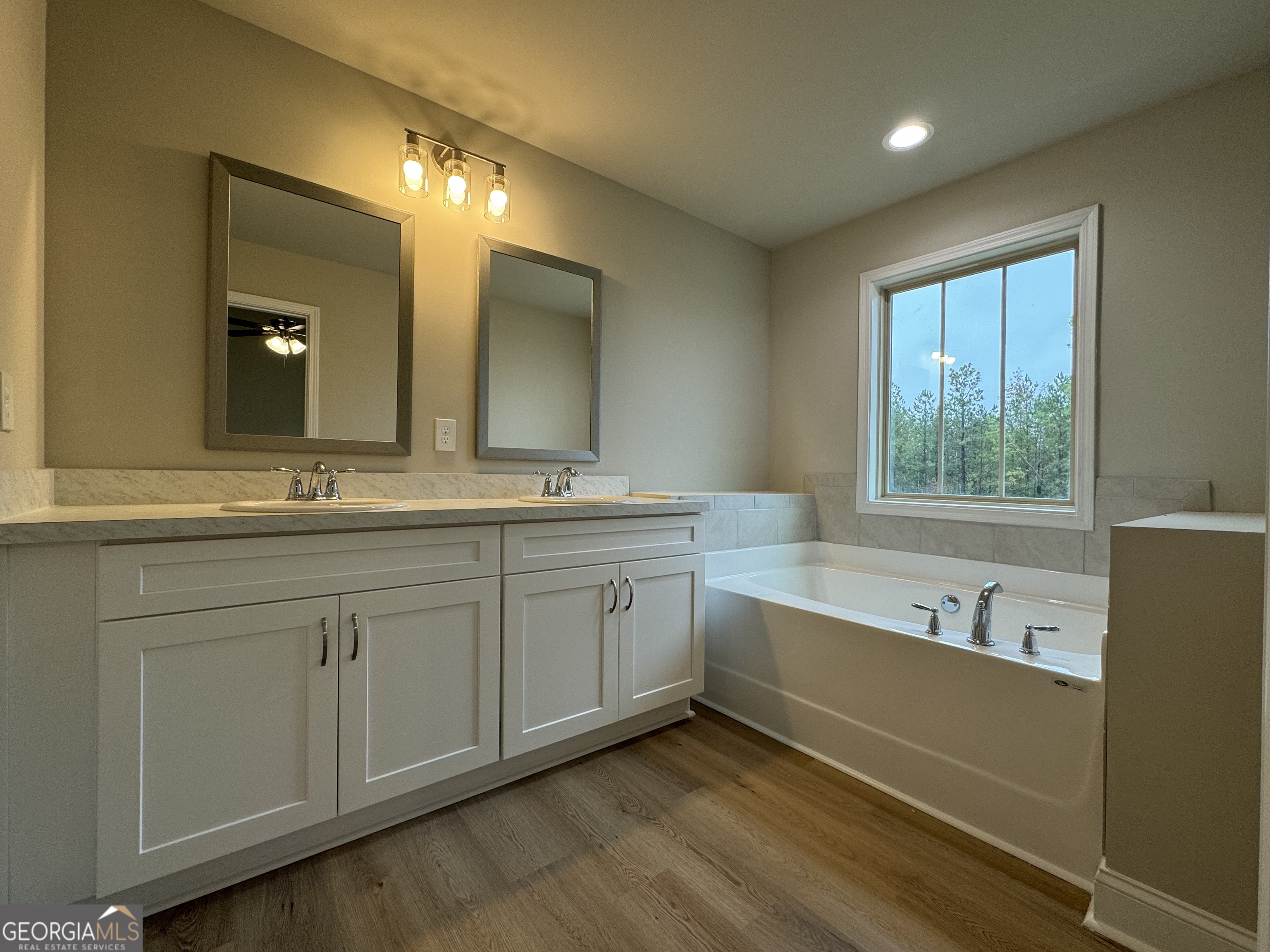 166 Country World Drive Macon, GA 31211 - Photo 21 of 33 a spacious bathroom with a double vanity sink a mirror and a bathtub