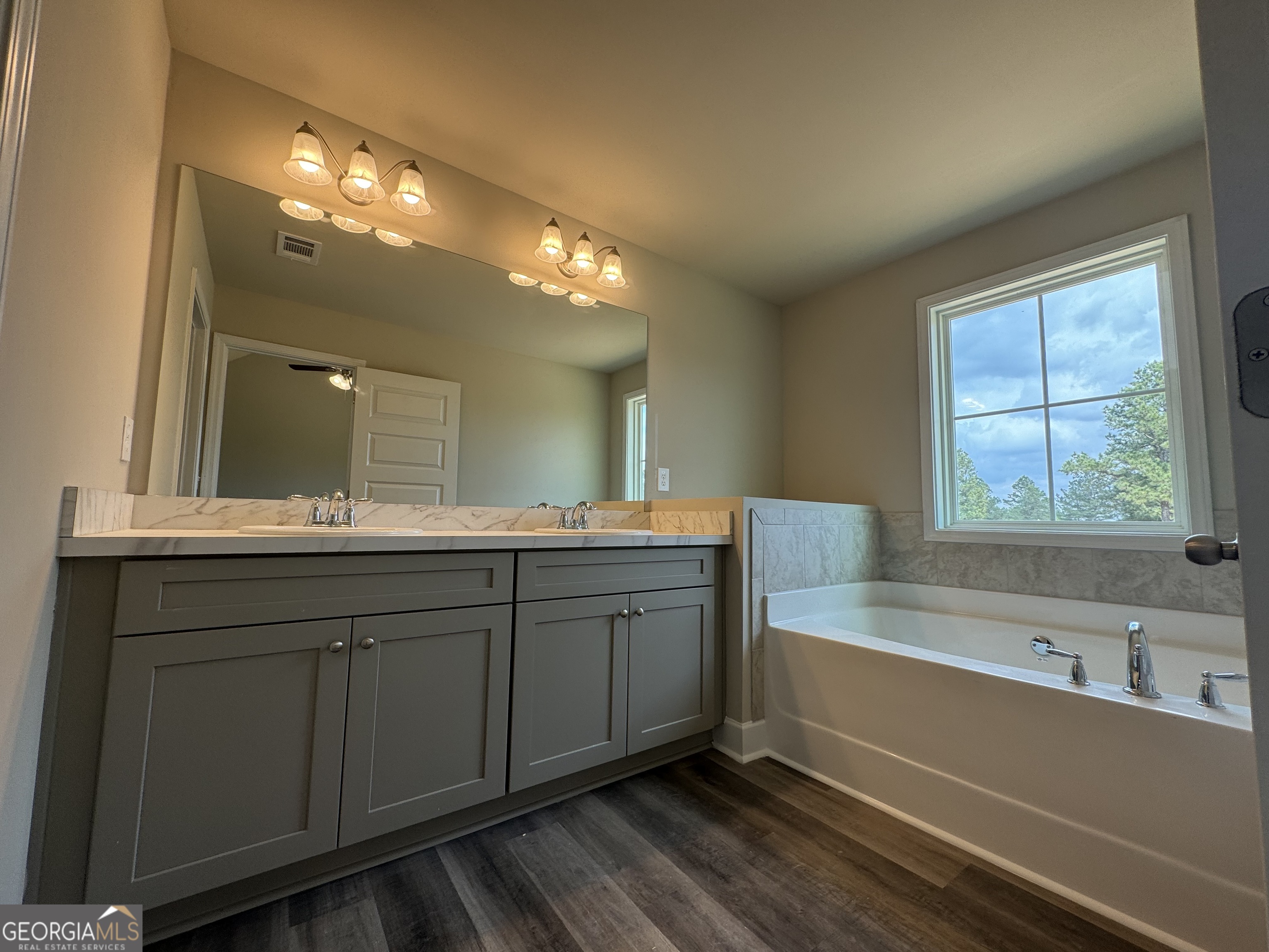 166 Country World Drive Macon, GA 31211 - Photo 32 of 33 a spacious bathroom with a large tub sink and vanity