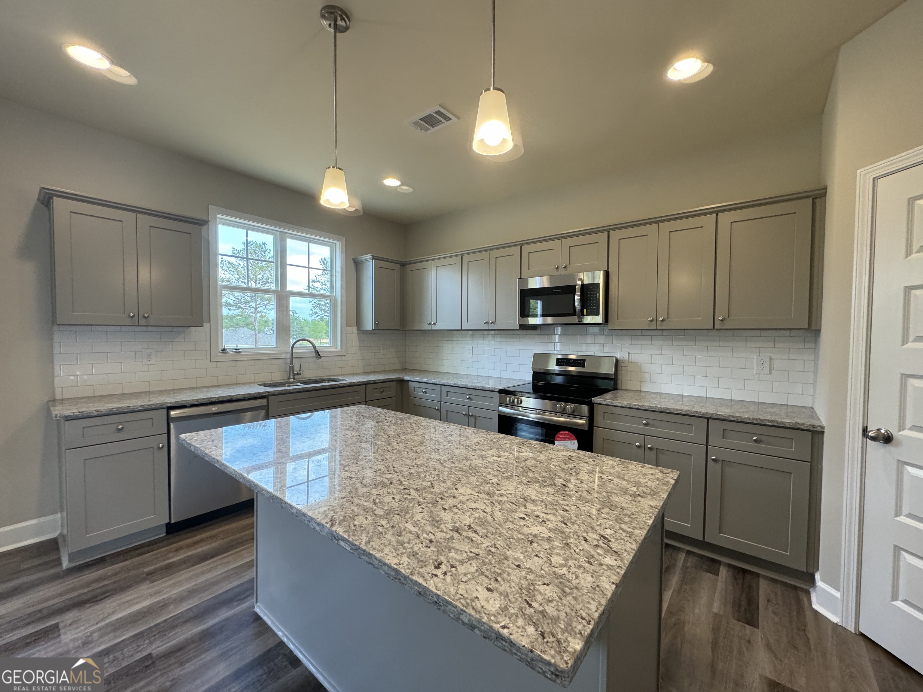 166 Country World Drive Macon, GA 31211 - Photo 33 of 33 a kitchen with stainless steel appliances granite countertop sink stove and refrigerator