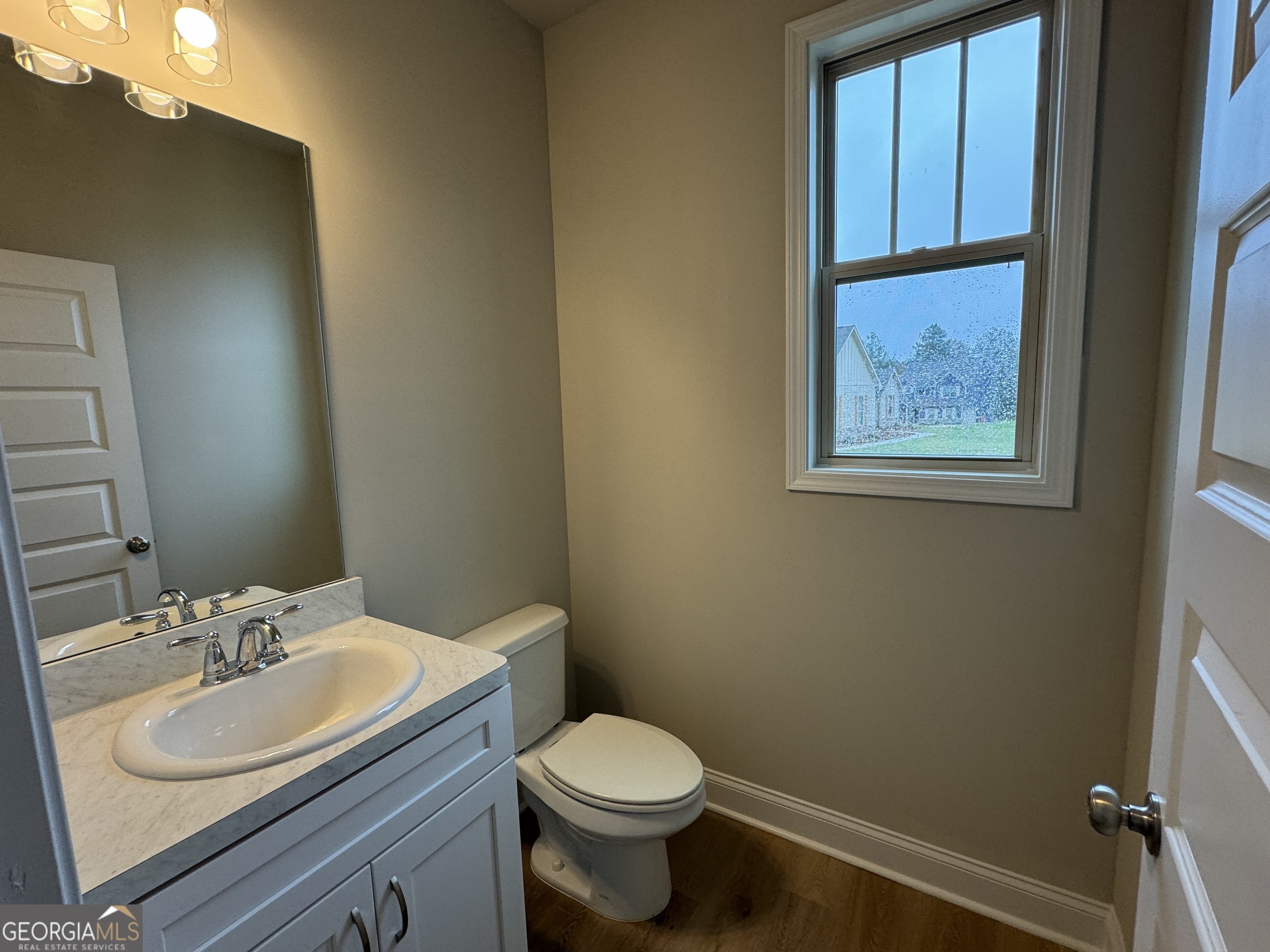 166 Country World Drive Macon, GA 31211 - Photo 4 of 33 a bathroom with a toilet sink and mirror