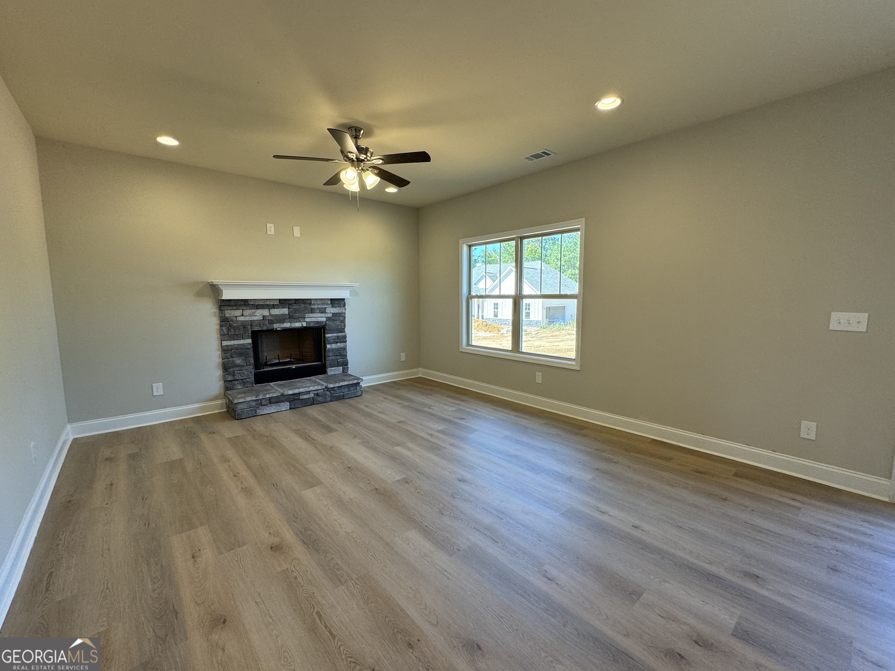 166 Country World Drive Macon, GA 31211 - Photo 5 of 33 an empty room with windows and fireplace