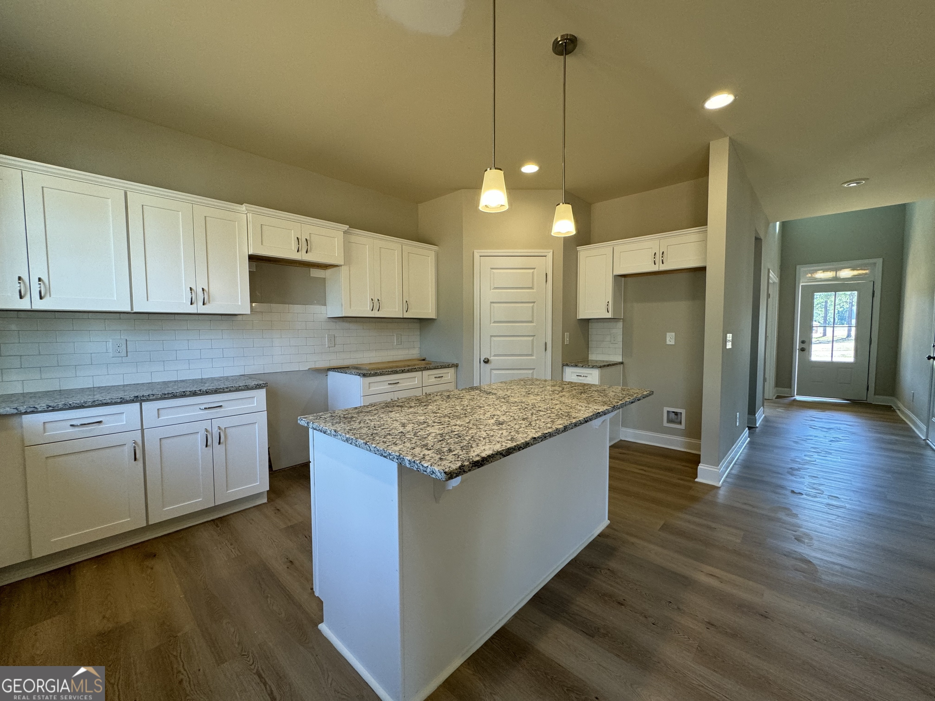166 Country World Drive Macon, GA 31211 - Photo 6 of 33 a kitchen with stainless steel appliances granite countertop wooden floors and view living room