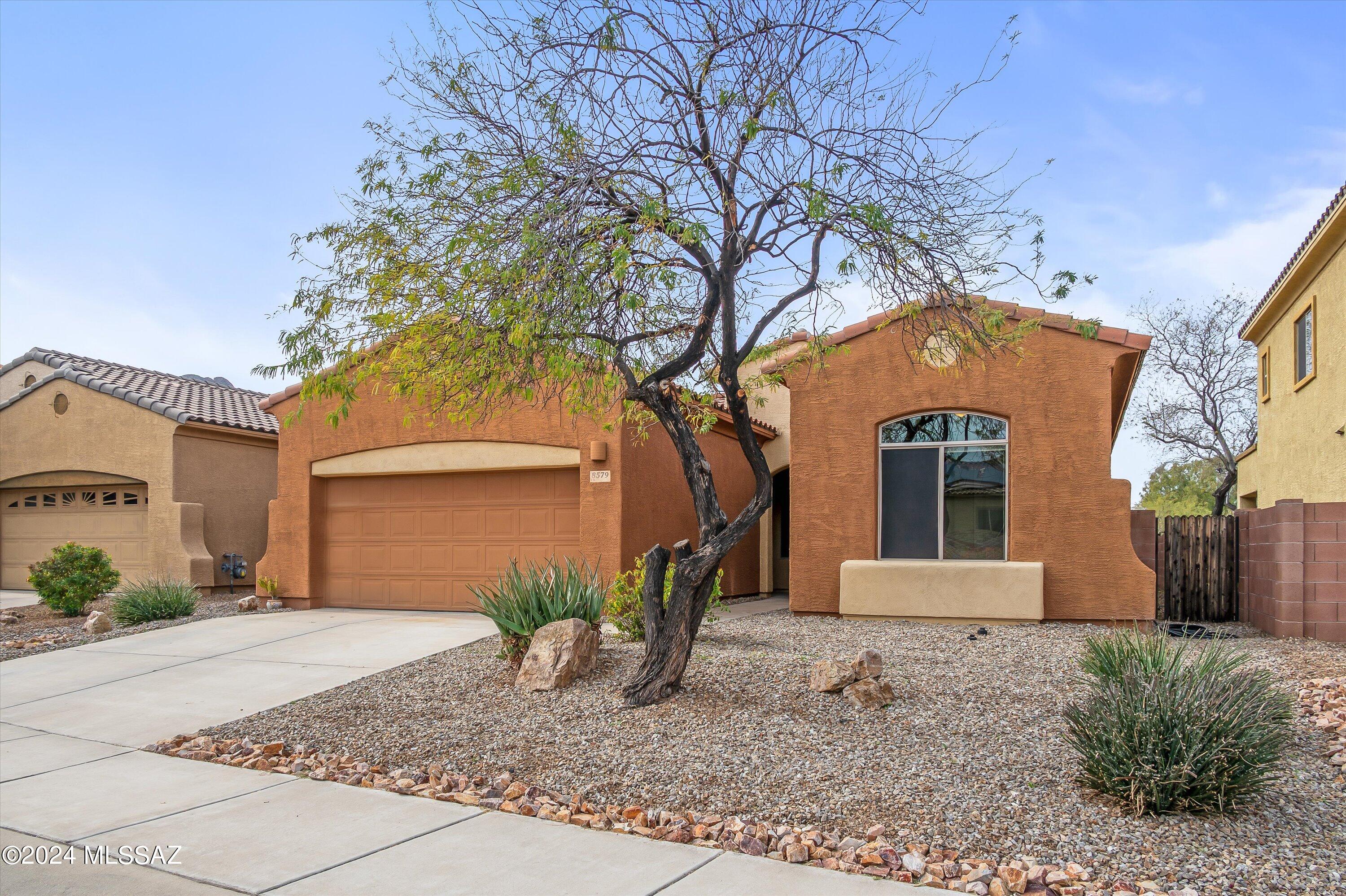 8579 North Shadow Wash Way Tucson, AZ 85743 - Photo 32 of 34 a front view of a house with garden