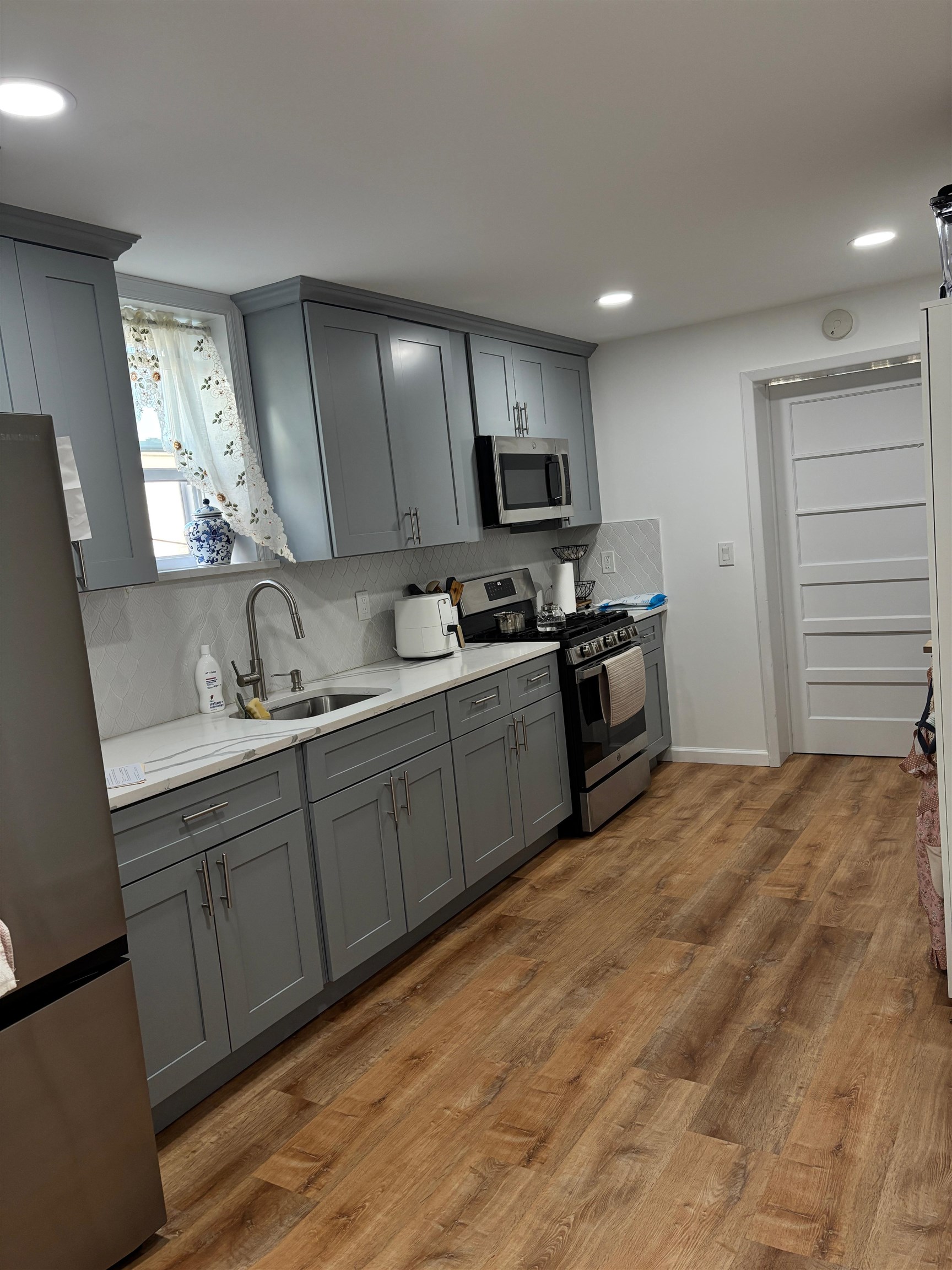 69 Poplar Street Jersey City, NJ 07307 - Photo 2 of 13 a kitchen with stainless steel appliances granite countertop a sink stove and refrigerator