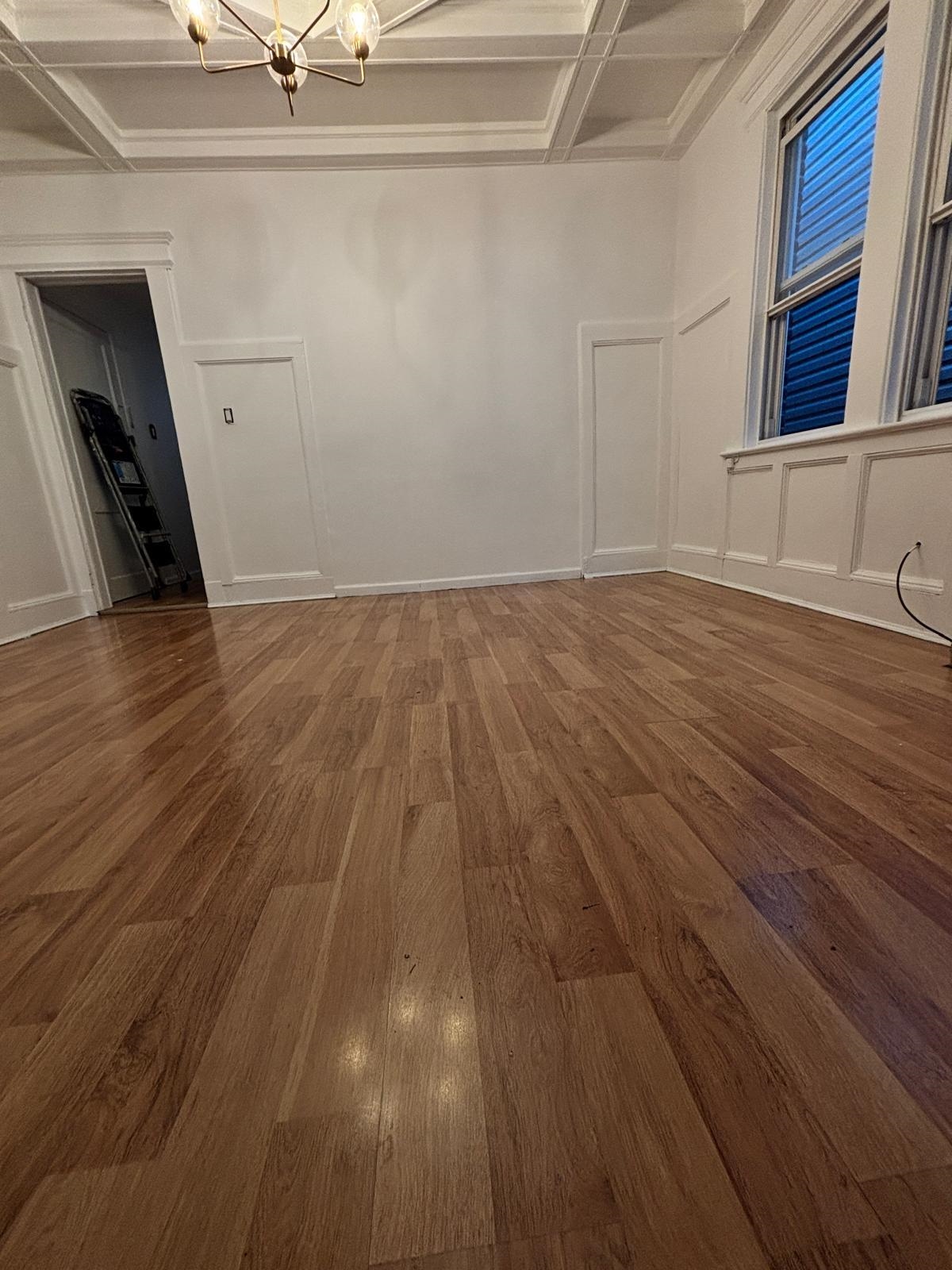 69 Poplar Street Jersey City, NJ 07307 - Photo 7 of 13 a view of an empty room with wooden floor and a window