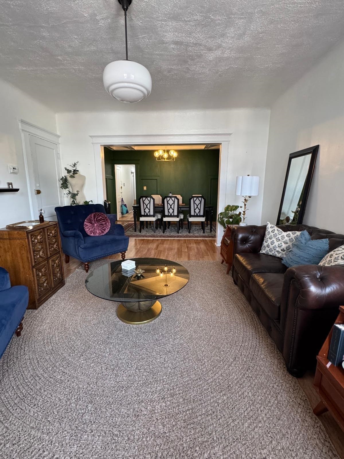 69 Poplar Street Jersey City, NJ 07307 - Photo 9 of 13 a living room with furniture and a chandelier