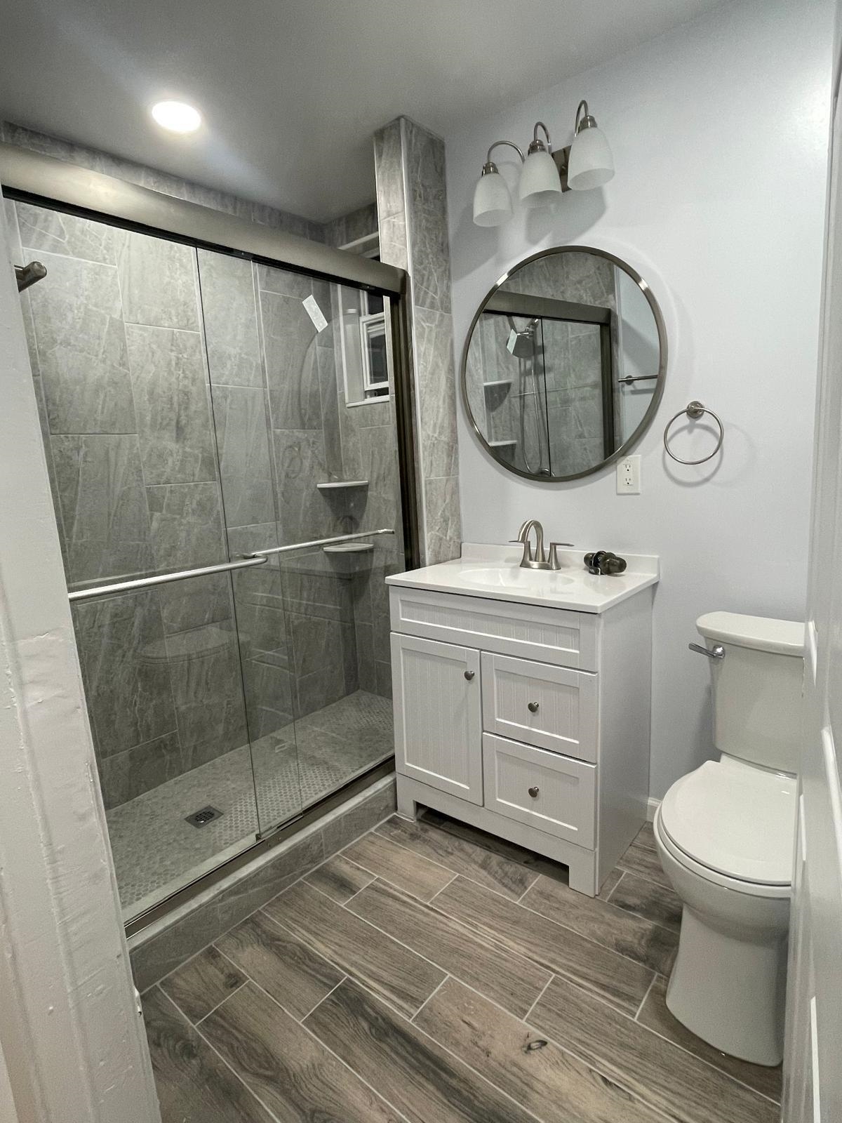 69 Poplar Street Jersey City, NJ 07307 - Photo 10 of 13 a bathroom with a toilet a sink and mirror