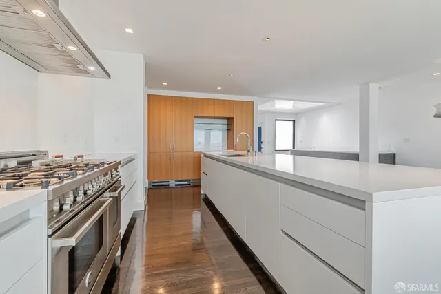 a stove top oven sitting inside of a kitchen