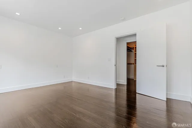 a view of an empty room and wooden floor