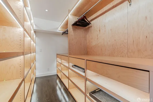 a white toilet sitting next to a white wall