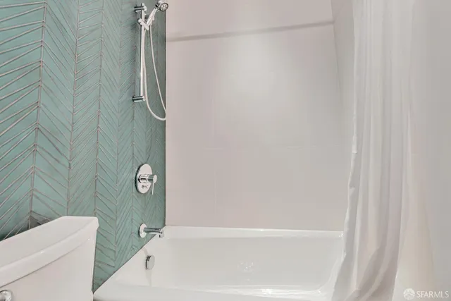 a bathroom with a sink and a large mirror next to a window