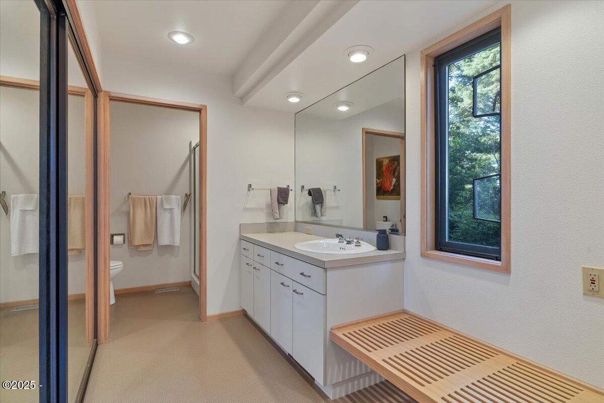 110 Ridge Crest Road Gleneden Beach, OR 97388 - Photo 44 of 72 a bathroom with a sink a mirror and a shower