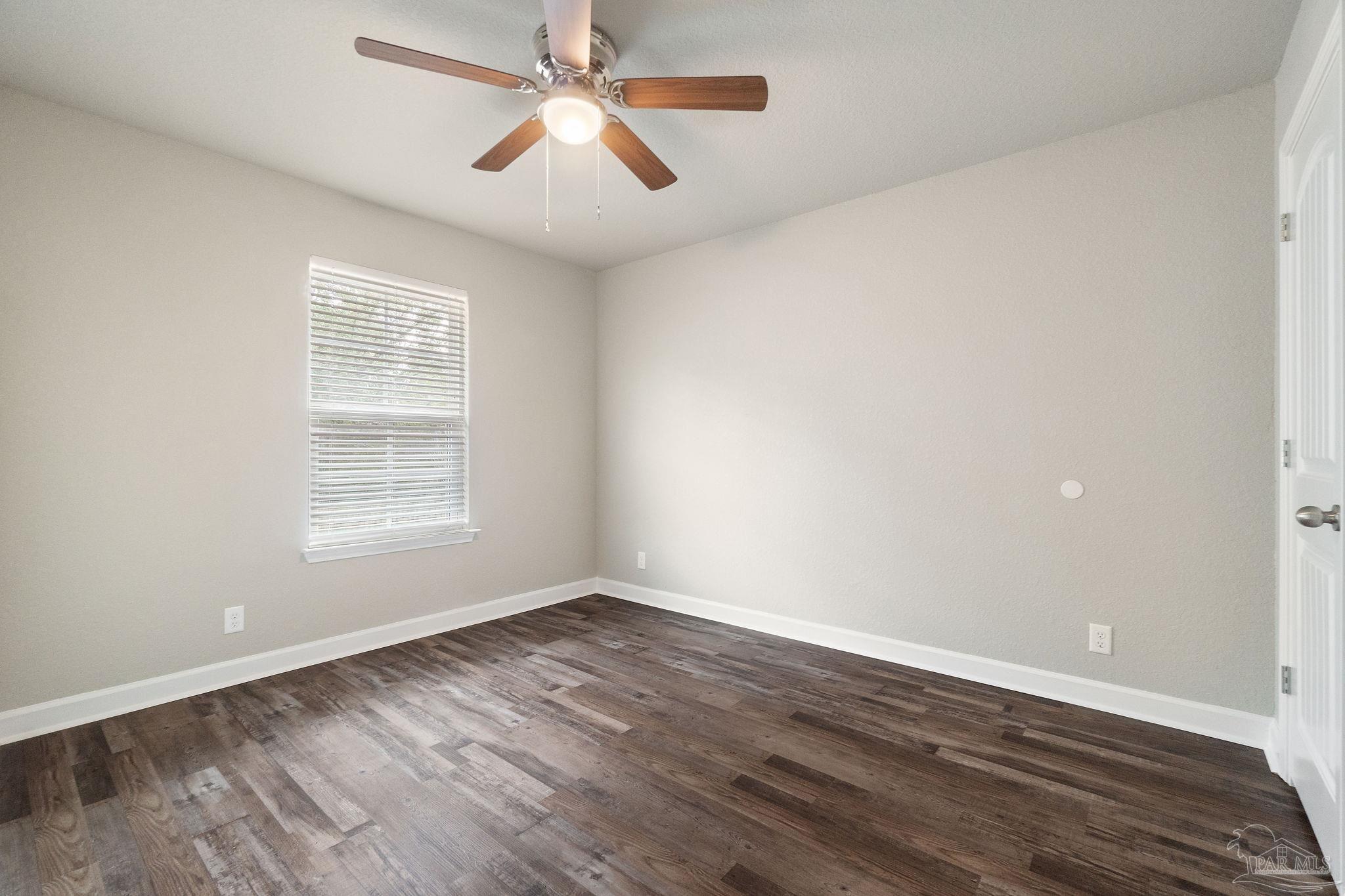 9906 Holsberry Road, Unit 1002 Pensacola, FL 32534 - Photo 12 of 14 wooden floor in an empty room with a window