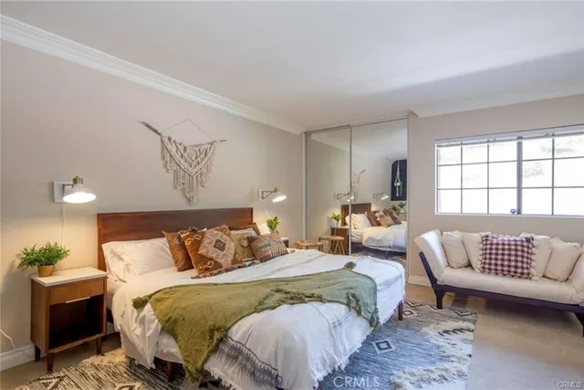 a bedroom with a bed and a couch