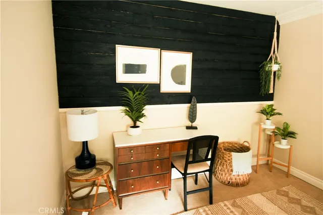 a living room with a couch and a potted plant