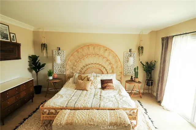 a bed sitting in a spacious bedroom next to a window