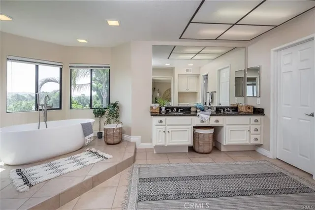 a large white kitchen with a stove a sink and dishwasher