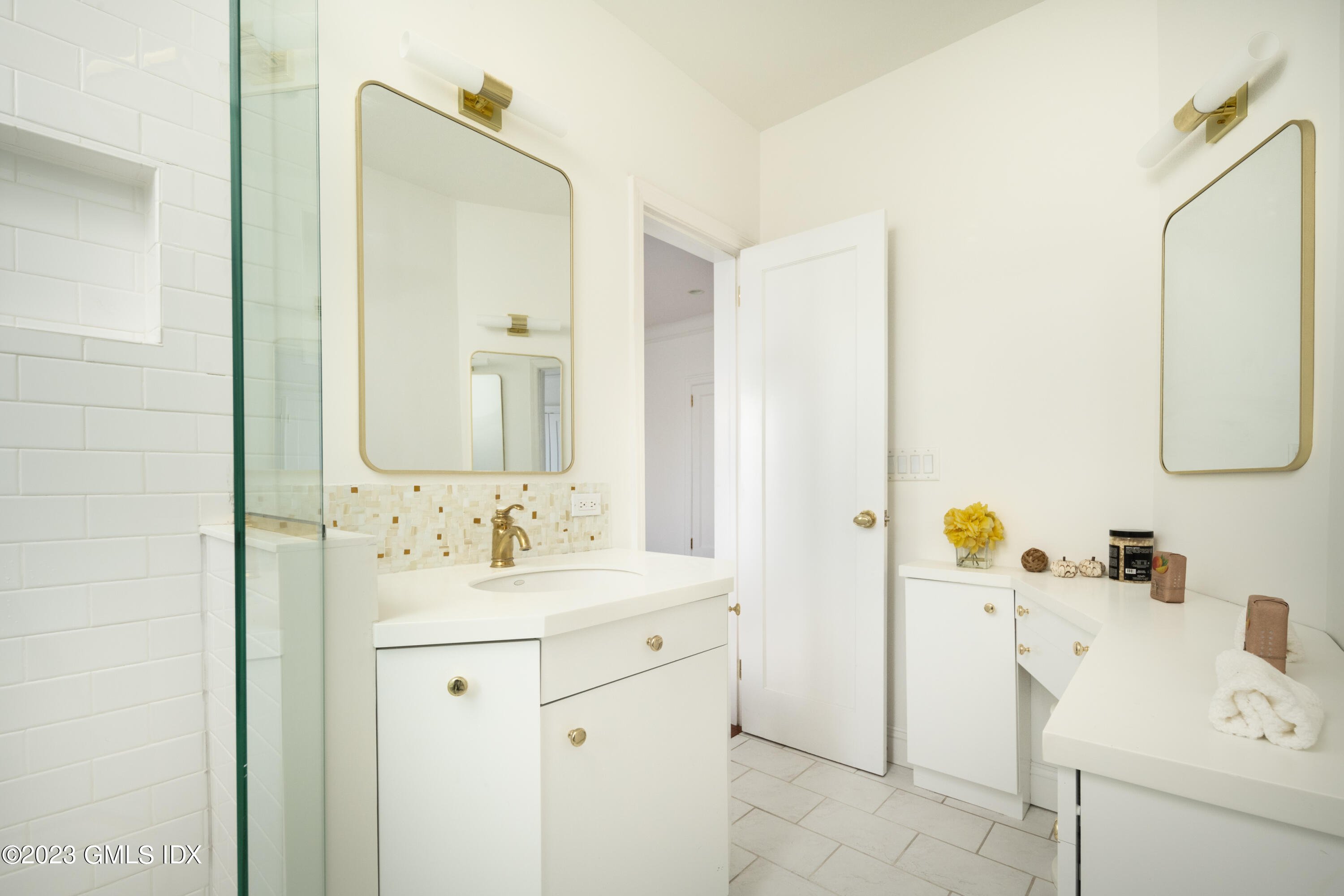 47 Lafayette Place, Unit 5F Greenwich, CT 06830 - Photo 12 of 18 a bathroom with a sink vanity and mirror