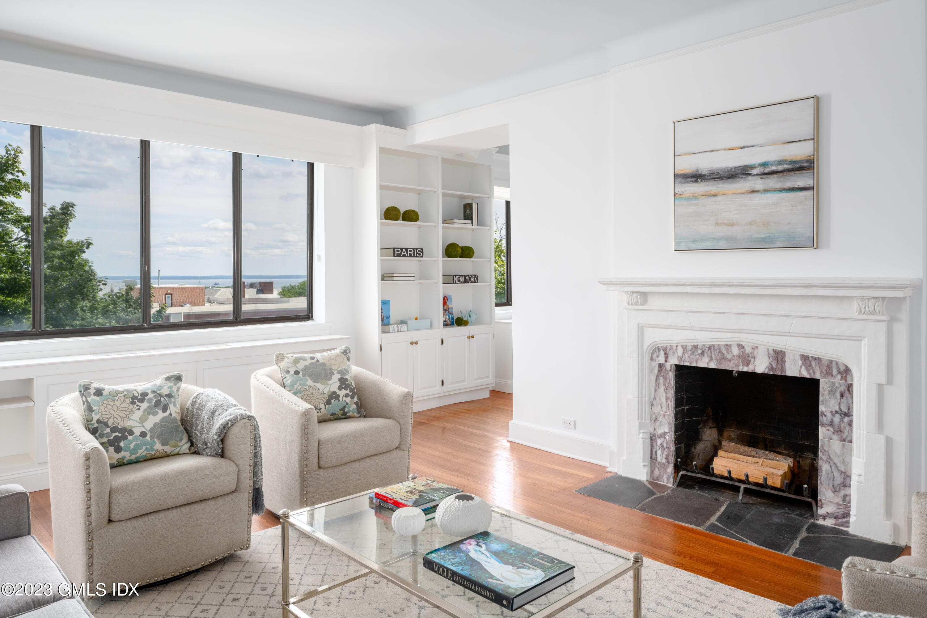 47 Lafayette Place, Unit 5F Greenwich, CT 06830 - Photo 2 of 18 a living room with furniture and a fireplace