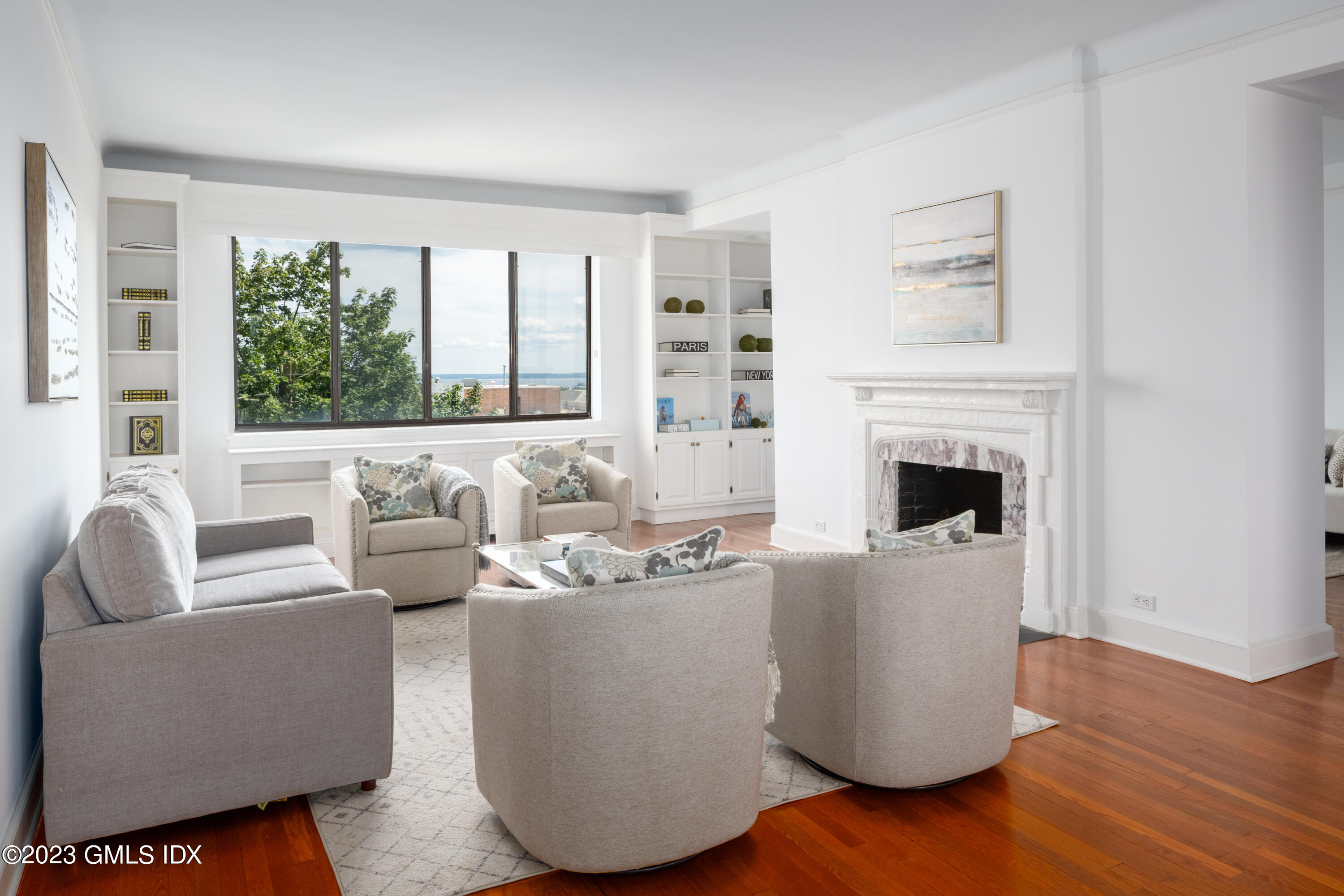 47 Lafayette Place, Unit 5F Greenwich, CT 06830 - Photo 4 of 18 a living room with furniture a fireplace and a large window