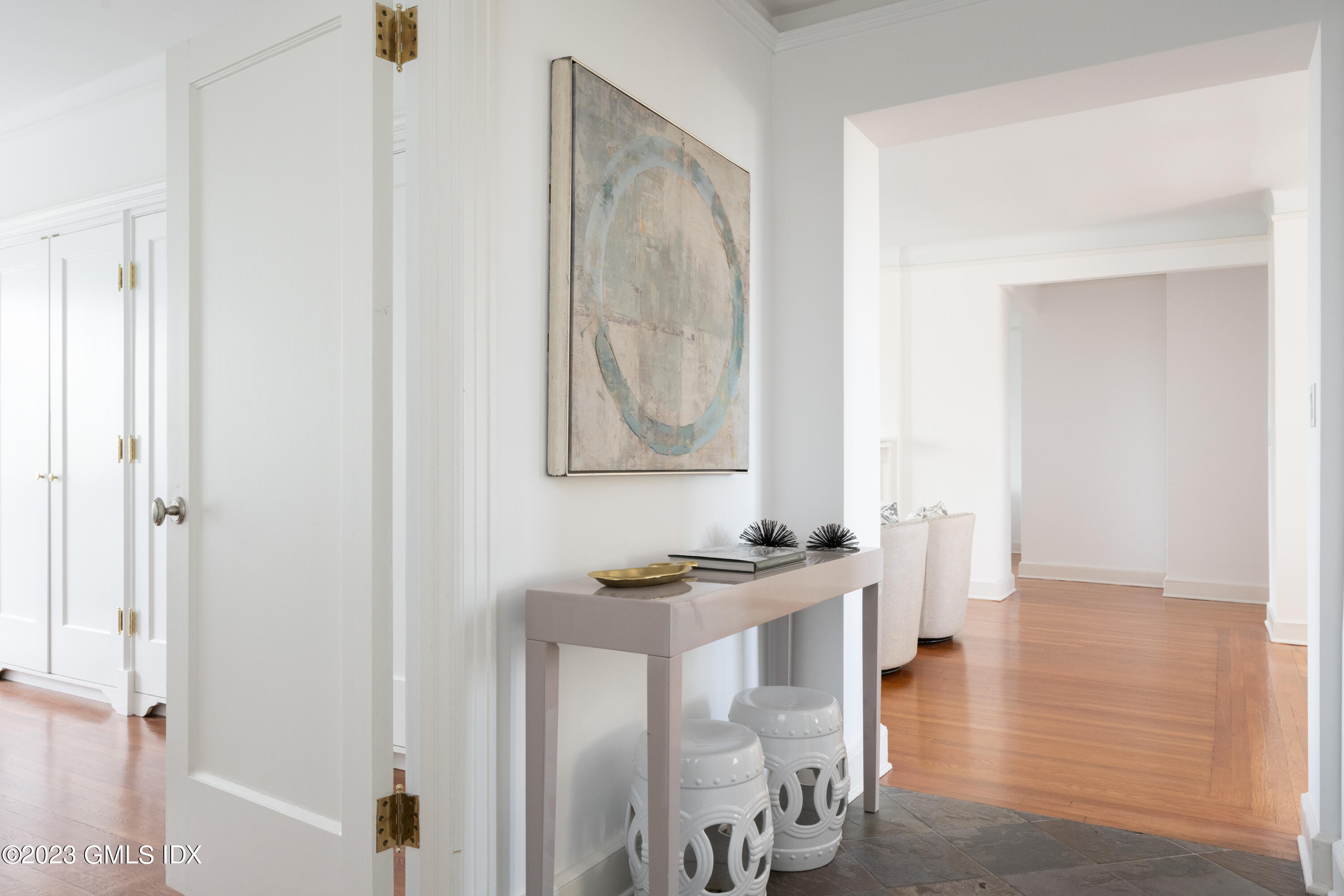47 Lafayette Place, Unit 5F Greenwich, CT 06830 - Photo 7 of 18 a view of a hallway with wooden floor and furniture