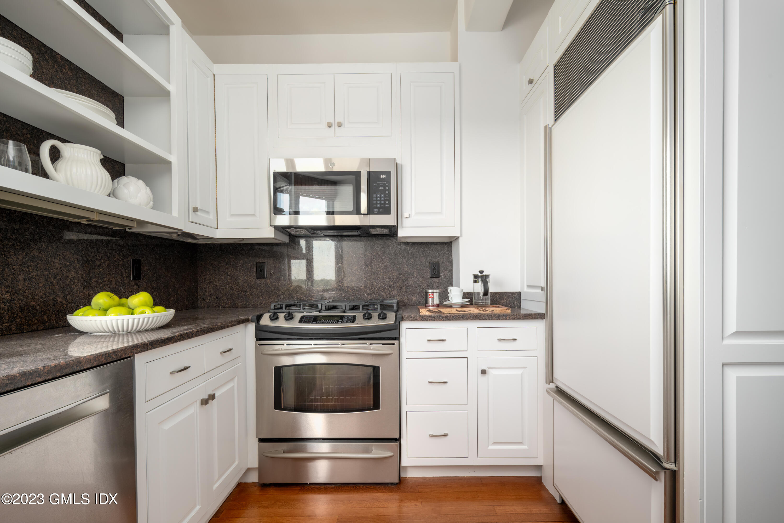 47 Lafayette Place, Unit 5F Greenwich, CT 06830 - Photo 9 of 18 a kitchen with stainless steel appliances granite countertop a stove a white cabinets and a sink