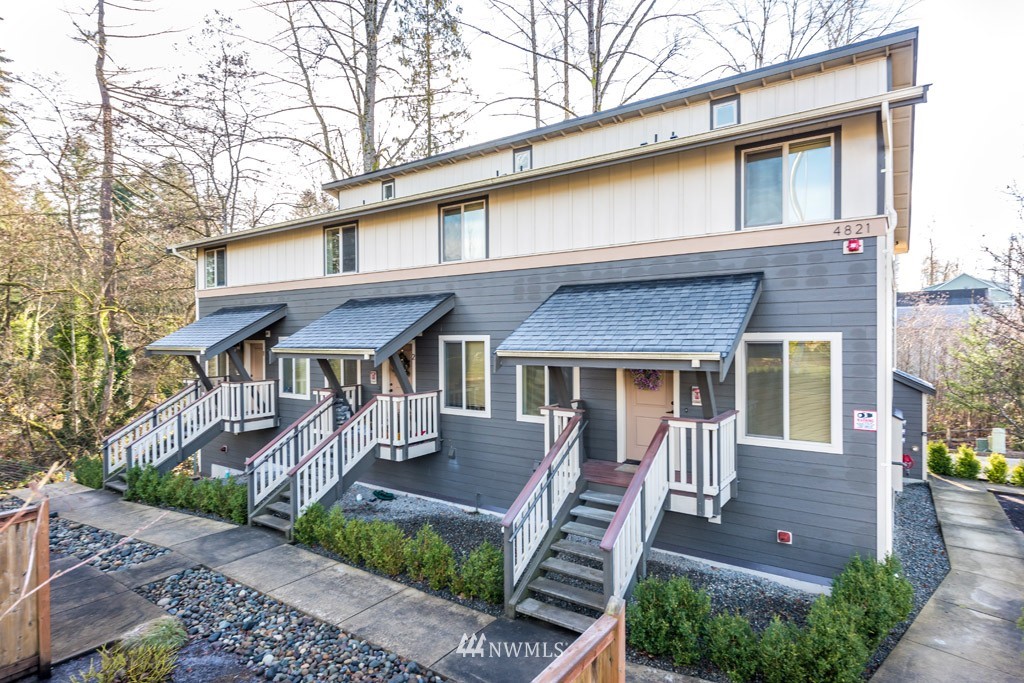 4821 Northeast Sunset Boulevard Renton, WA 98059 - Photo 1 of 12 a front view of a house with a garden
