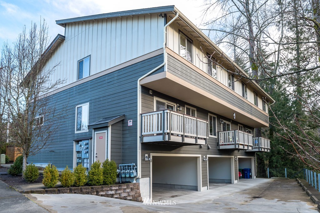 4821 Northeast Sunset Boulevard Renton, WA 98059 - Photo 4 of 12 a front view of a house with a balcony