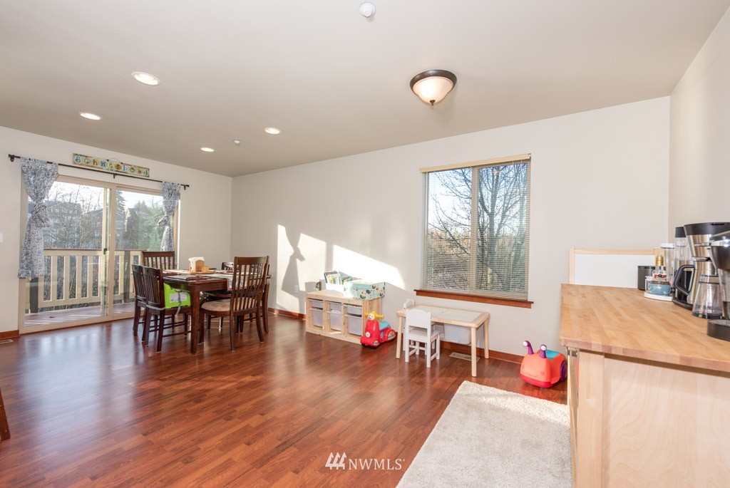 4821 Northeast Sunset Boulevard Renton, WA 98059 - Photo 8 of 12 a living room with furniture and a wooden floor